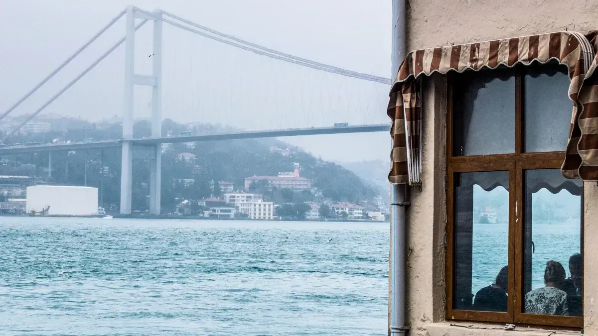 2 Guys talking on a wall waiting to cross the Bosphorus, Istanbul, Turkey