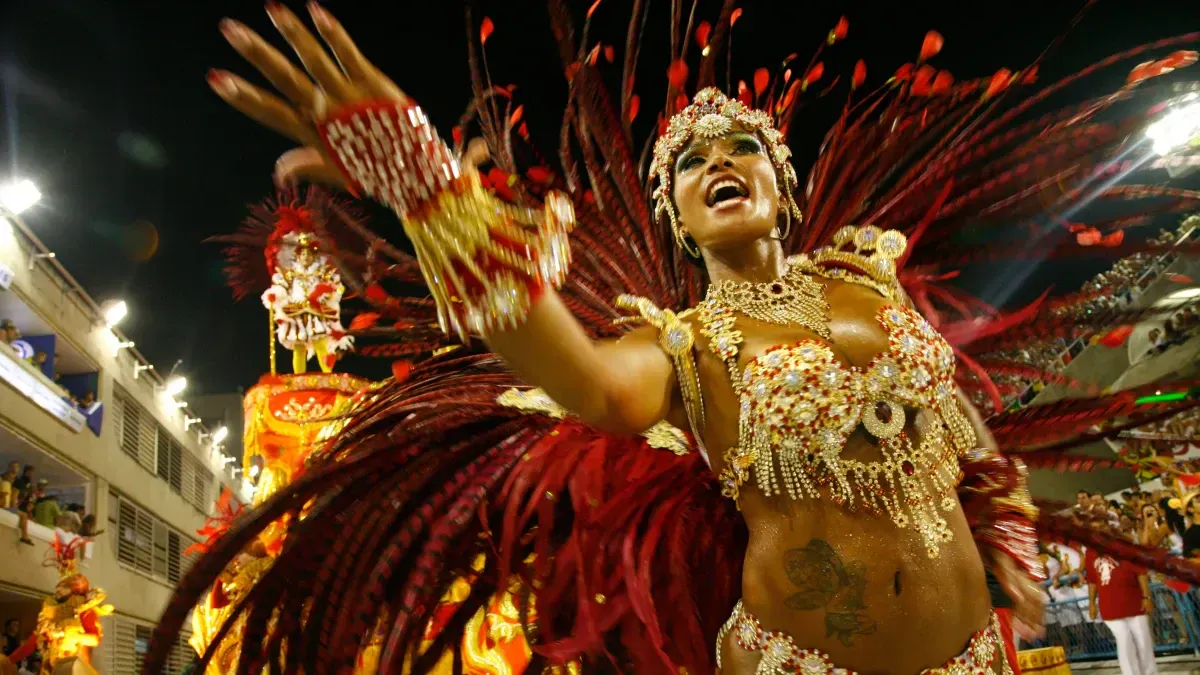 Premium Photo  Three woman in brazilian samba carnival costume with  colorful feathers plumage