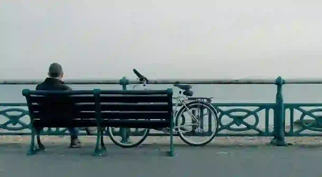 Man with a bicycle on Brighton Seafront