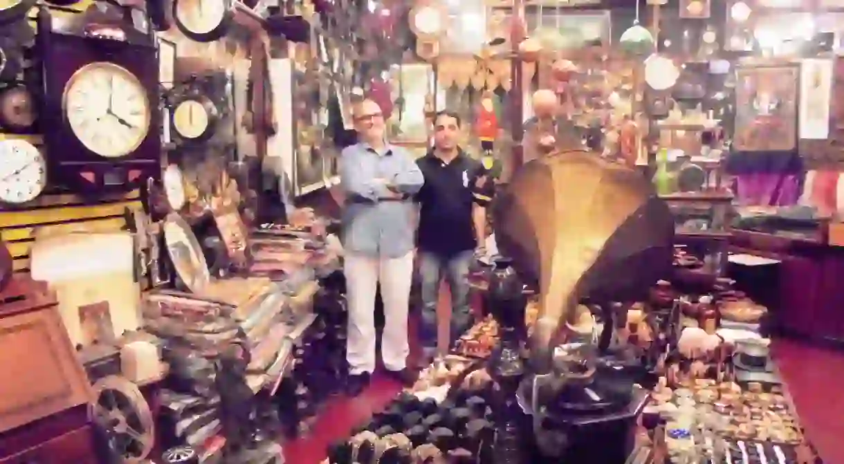 Mohamed Lateef and Bashir posing among curios, Old Curiosity Shop