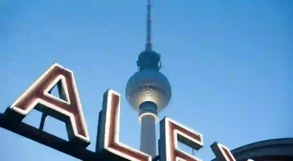 ther berlin fernsehturm tv tower and a neon sign at alexanderplatz