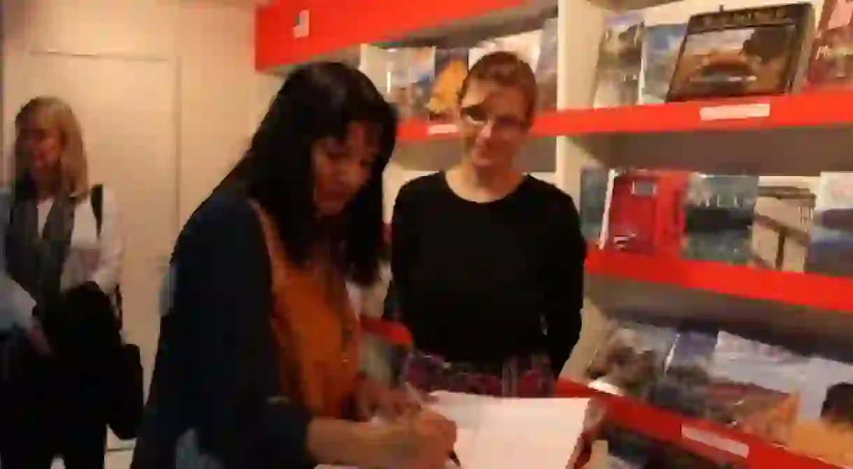 Cisneros signing a book for a fan l