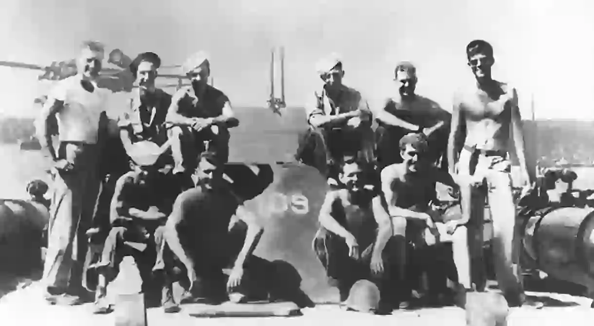 Lieutenant John F. Kennedy, USNR, (standing at right) with other crewmen on board PT-109, 1943.