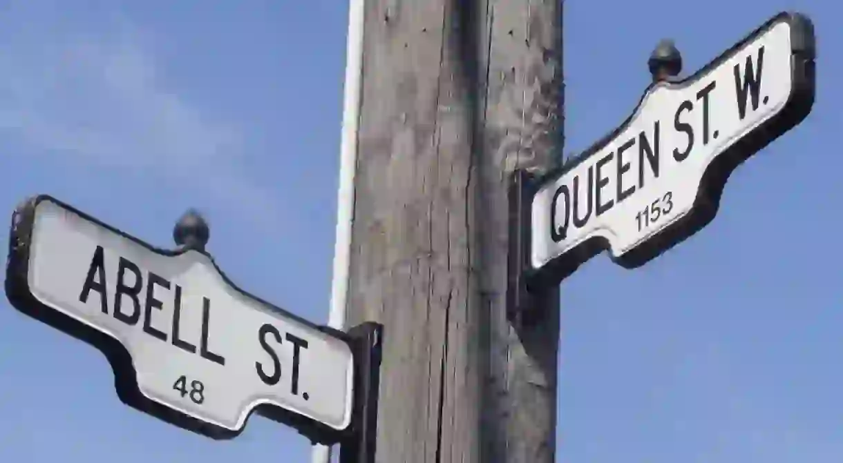 Street signs for Queen Street West and Abell Street