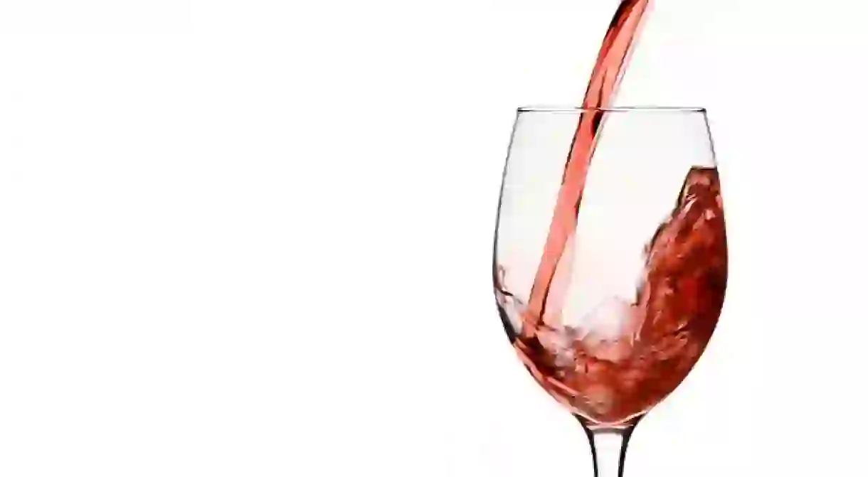 Pouring Red Wine in to Wine Glass