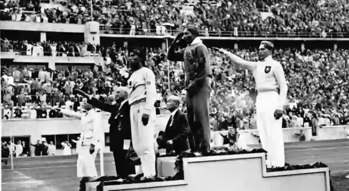 Jesse Owens winning first place at the 1936 Olympics