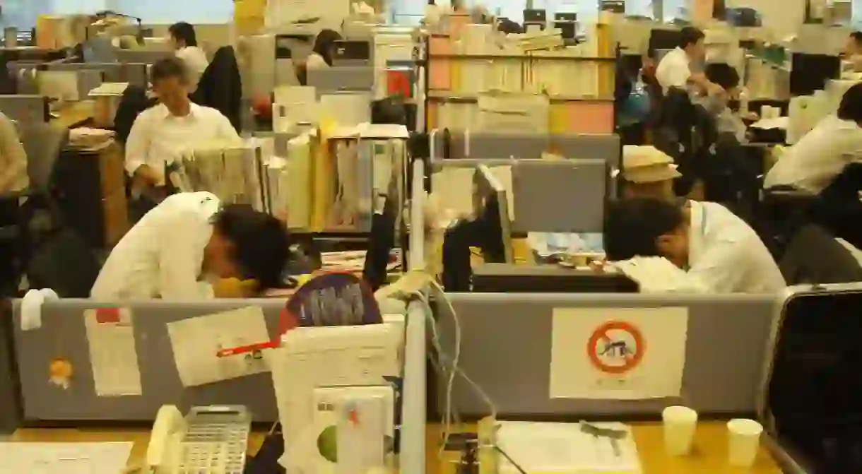 Office workers practicing inemuri at the office