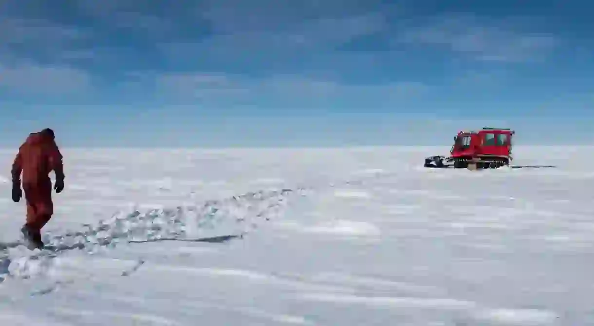 A member of the Concordia team walks across the Antarctica Ice