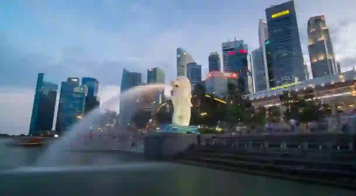 Singapore Merlion at Marina Bay against the city skyline in the evening