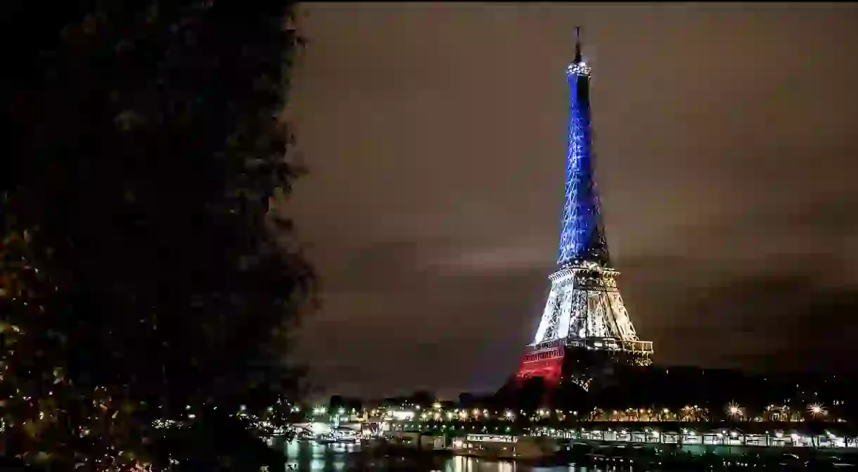 The Eiffel Tower lit in blue, white, and red │