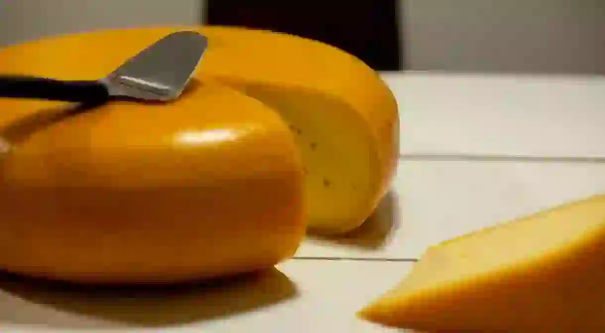 A golden wheel of Gouda cheese