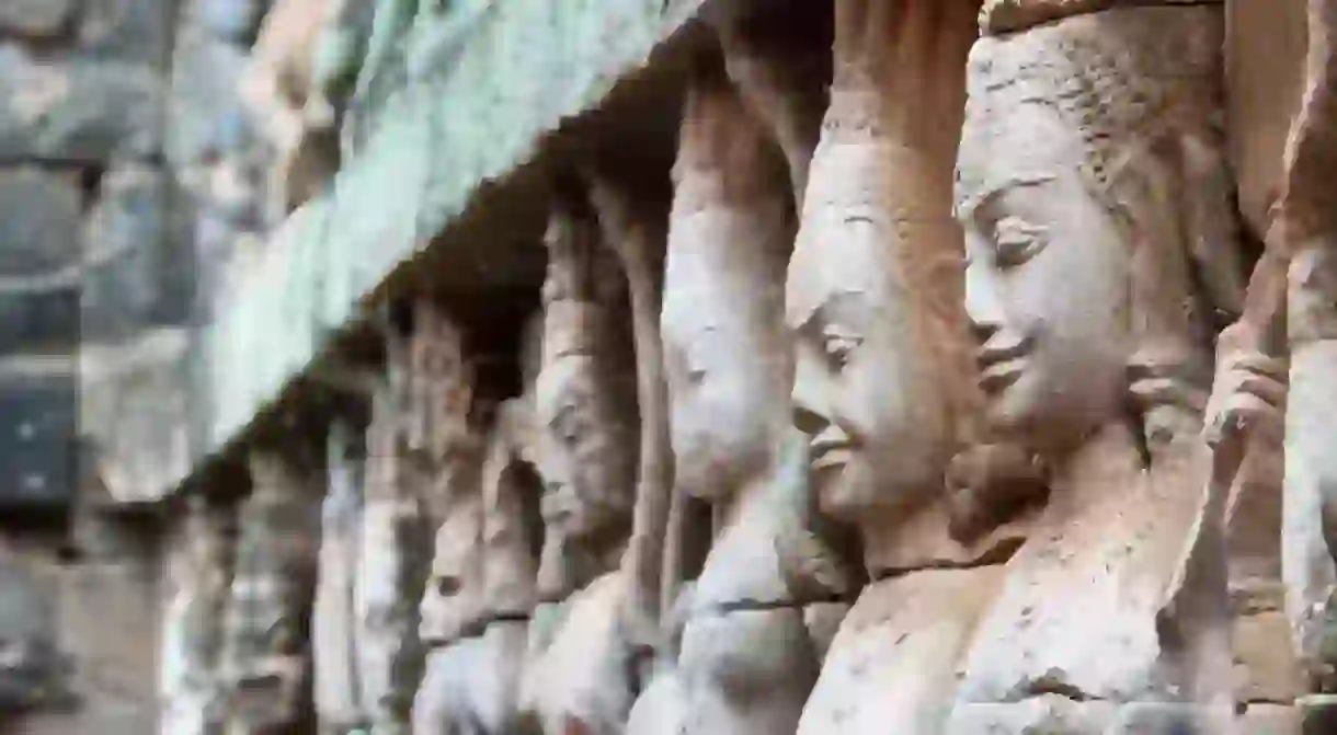 Apsara dancers can be seen carved into the walls at Angkor