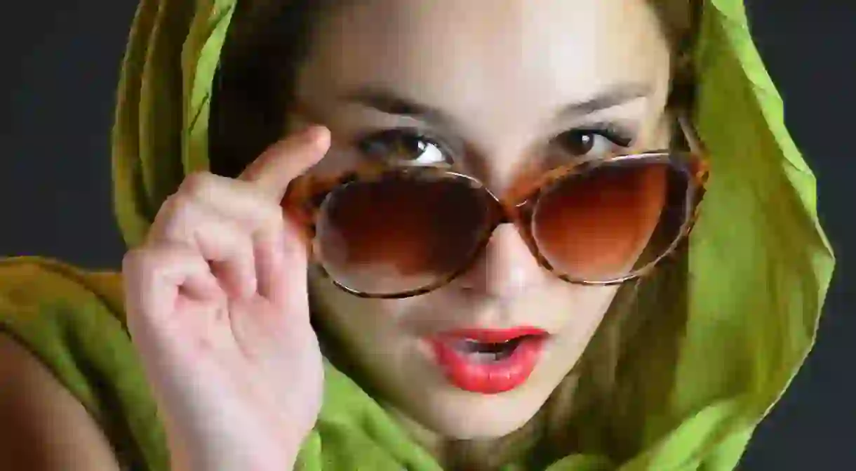 Woman wearing a scarf and sunglasses