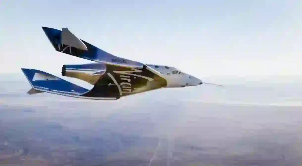 Virgin Spaceship Unity (VSS Unity) glides for the first time after being released from Virgin Mothership Eve (VMS Eve) over the Mojave Desert