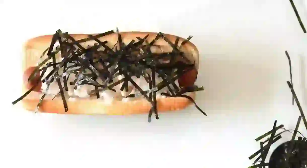 Hot dog sprinkled with seaweed and mayonnaise