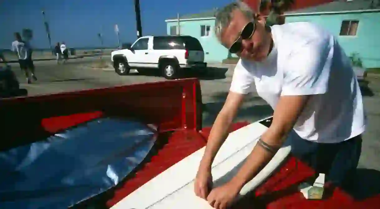 Tom Delonge with a surfboard