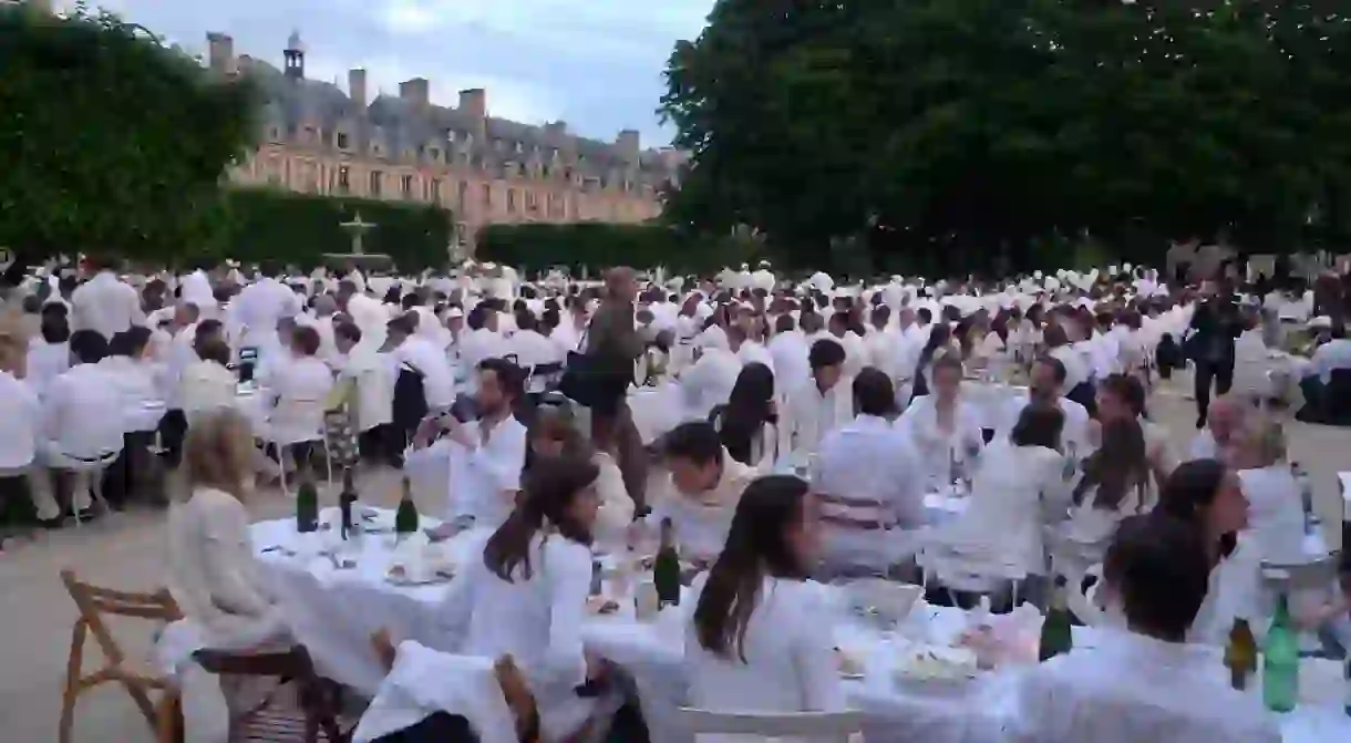 White dinners are a chic affair where everyone brings a picnic and tables and has a pop up dinner