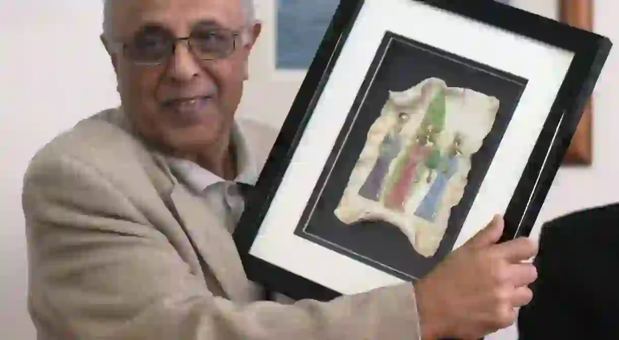 Kathrada shows a present he received during a ceremony held in his honor on April 29, 2004 at the Headquarters of the Afro World of Montevideo