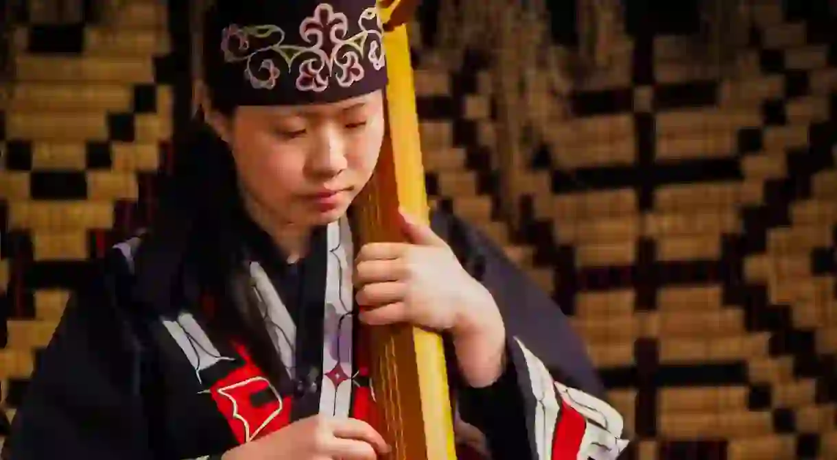 Ainu woman playing an instrument