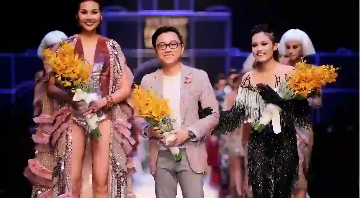 Vietnamese Designer Nguyen Cong Tri Poses with Models After the Presentation of His Collection During the Vietnam International Fashion Week