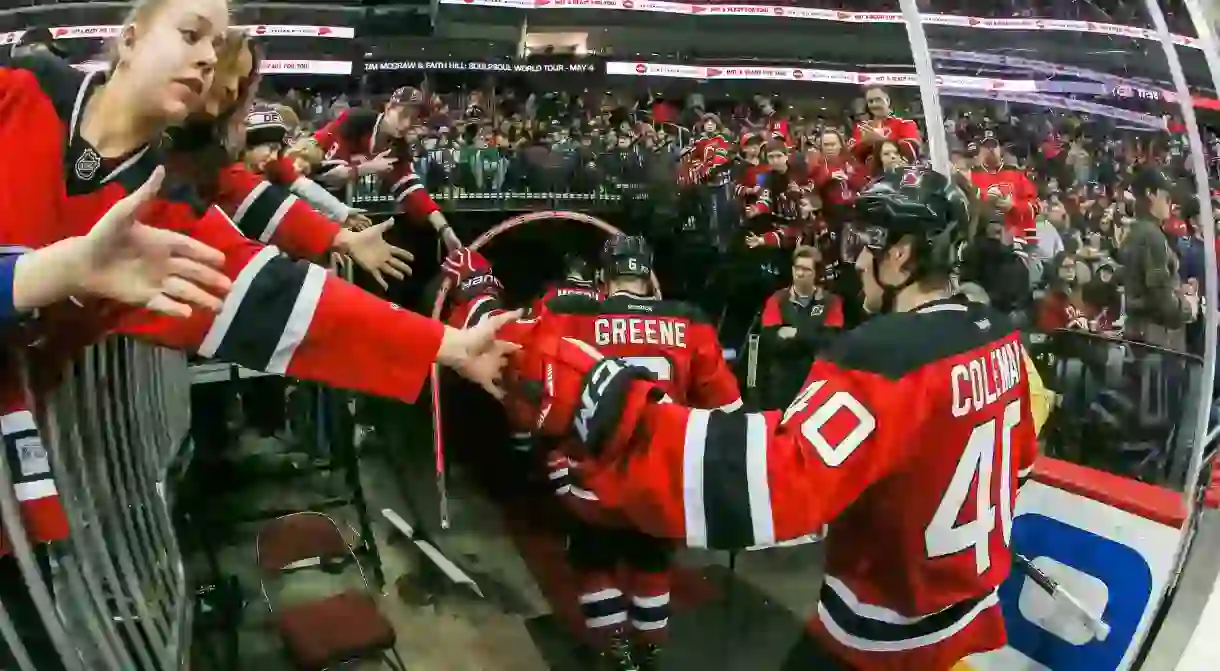 Devils Blake Coleman (40) and Andy Greene (6) acknowledge fans as they come off the ice