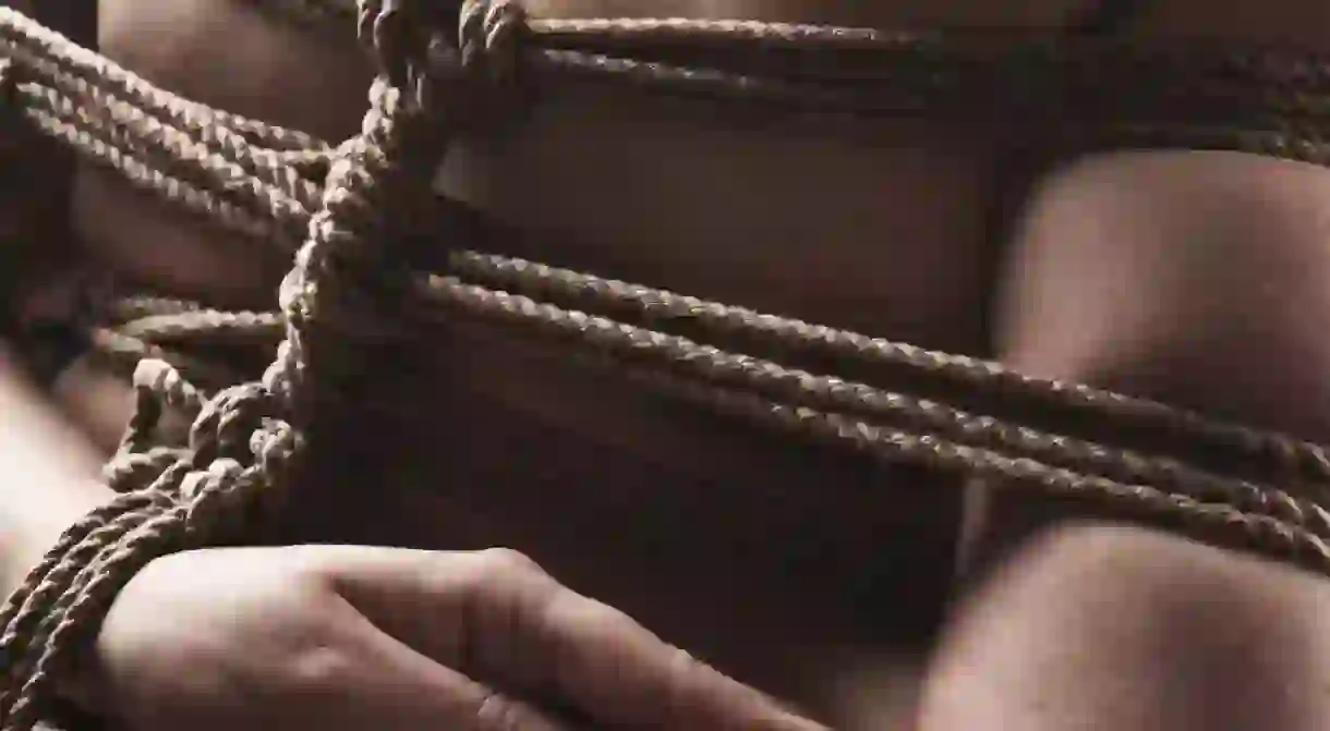 Young submissive woman in japanese bondage