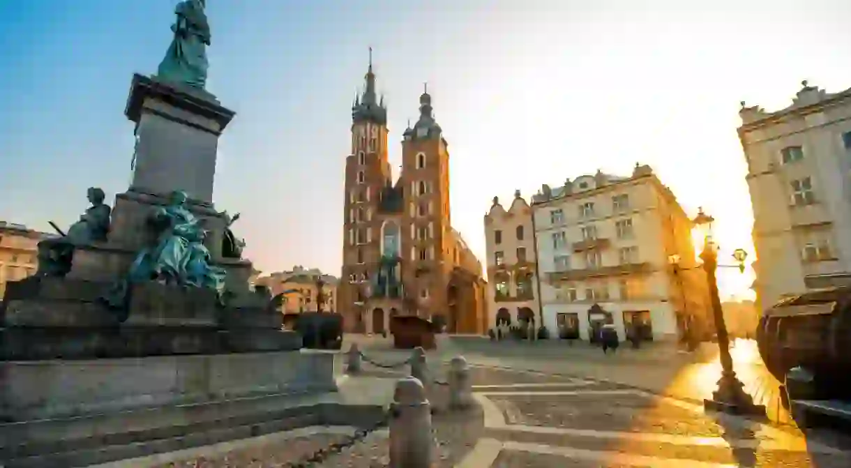 Adam Mickiewicz monument and St. Marys Basilica in Krakow