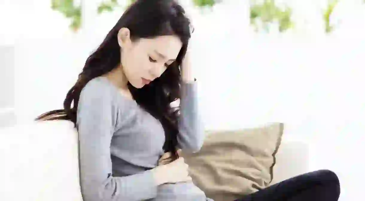 A woman rubbing her stomach