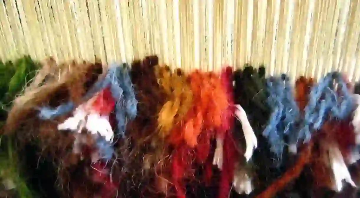 The process of rug weaving on a loom