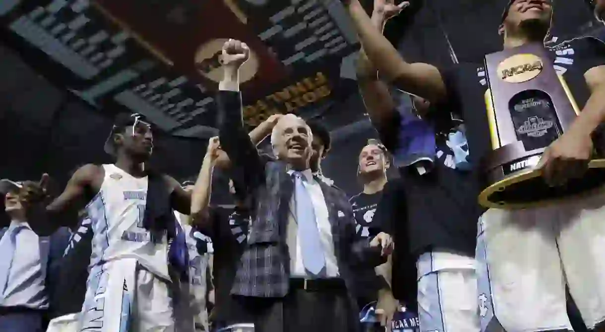 UNC coach Roy Williams and players celebrating winning the 2017 NCAA Tournament