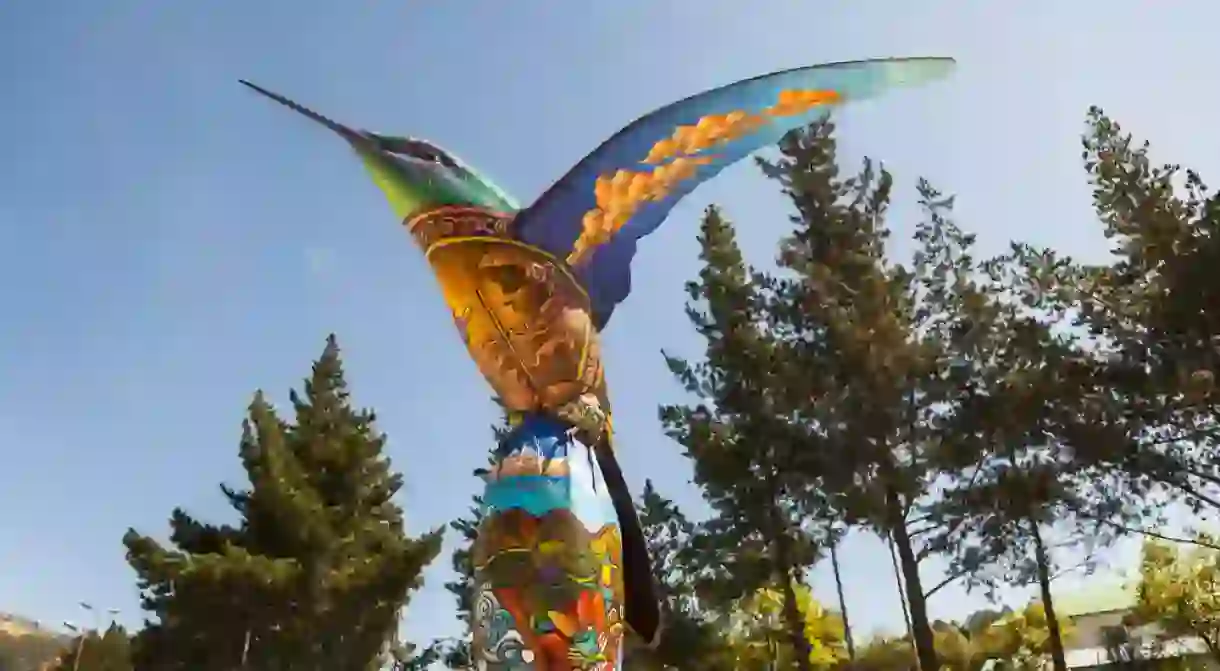 Hummingbird sculpture, painted by visual artists in the park colibries in the city in Quito. Ecuador