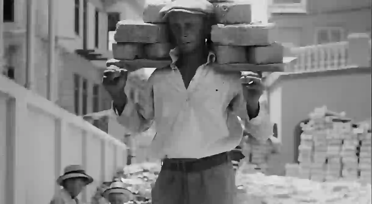 A worker carries bricks to build the first Hebrew city, Tel Aviv