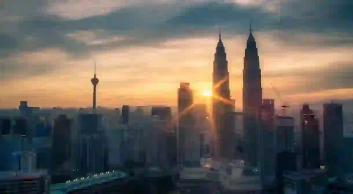 Sunburst over Kuala Lumpur cityscape