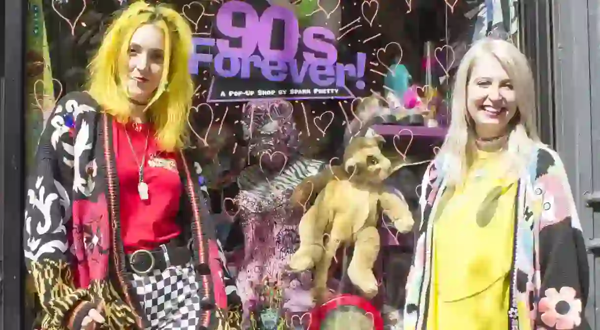 Amanda Dolan and Meagan Colby pose in front of their Spark Pretty ’90s pop up shop