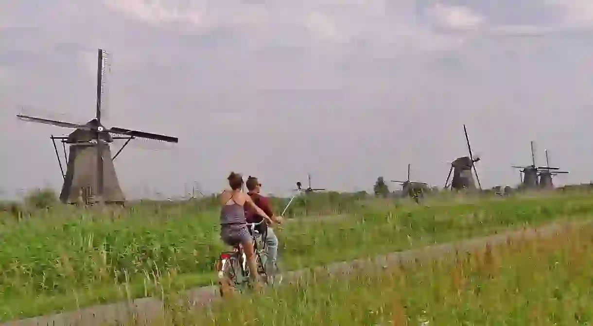 Cyclists riding through Kinderdijk Mill Network