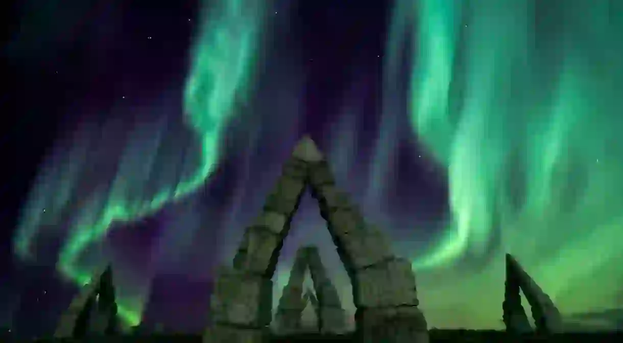 Aurora borealis flying over the Artic Henge, Iceland