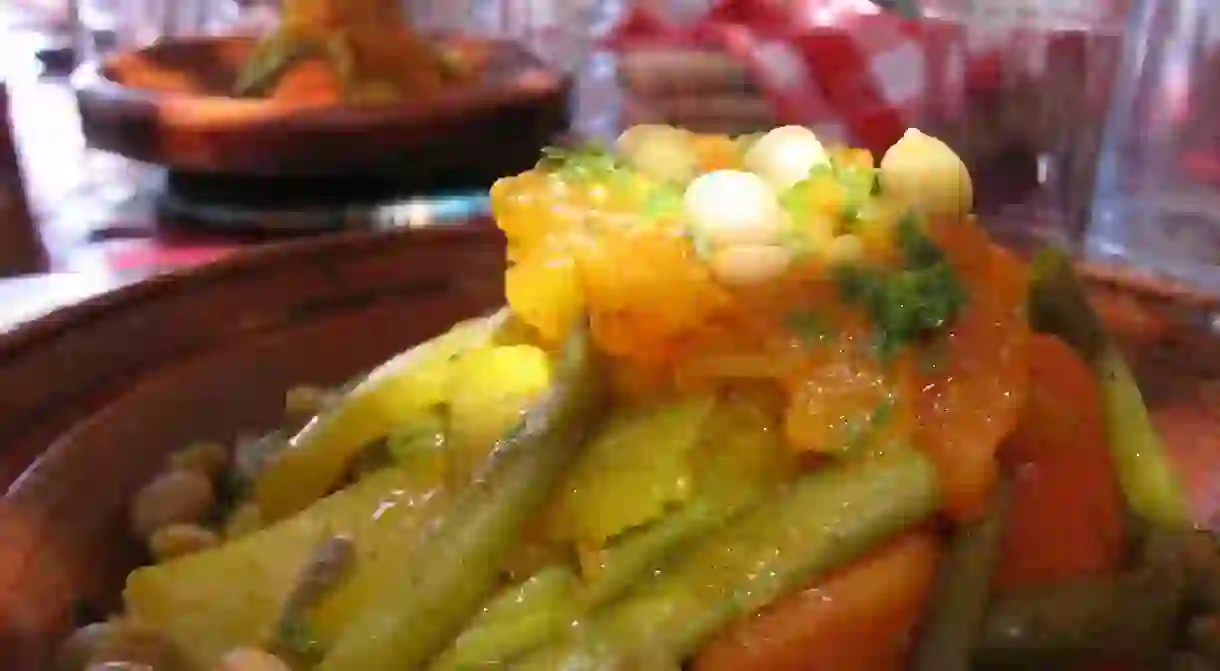 A close-up shot of a traditional tagine in a Moroccan restaurant