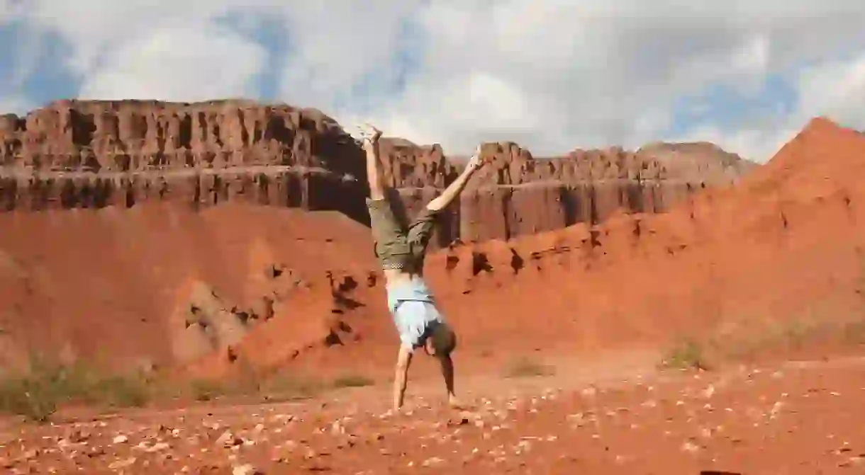 Traveler doing a handstand in Las Conchas, Salta, Argentina