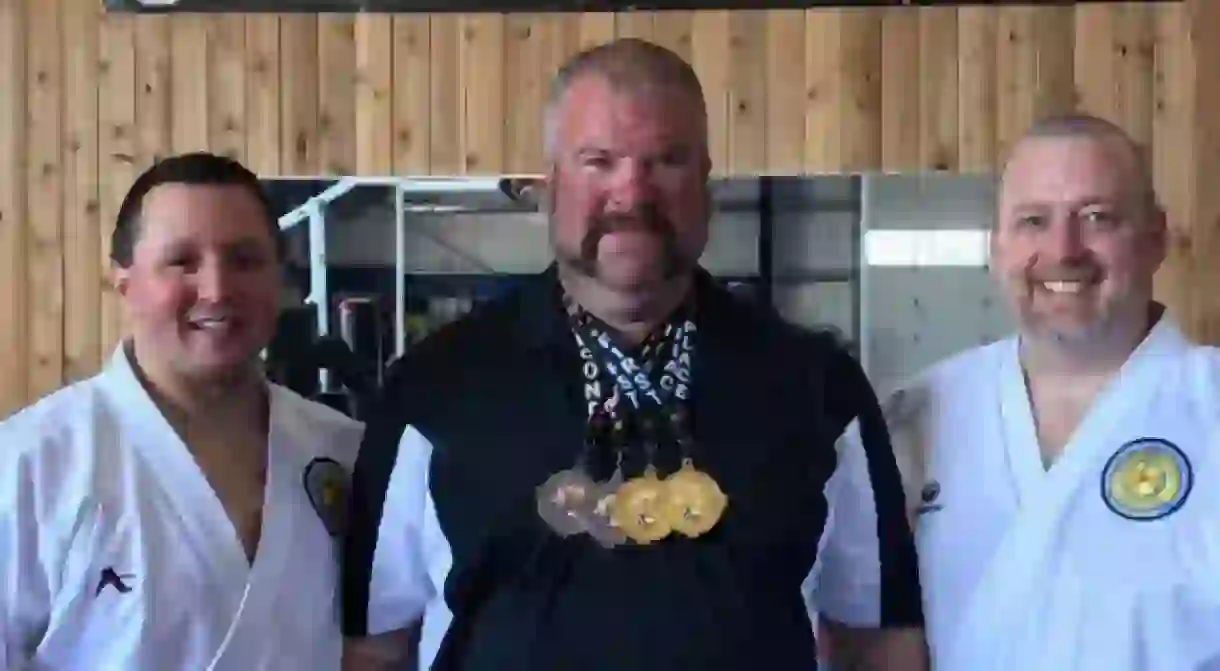 Shawn Buller (center) won four medals at the 2017 U.S. National Sumo Championships.