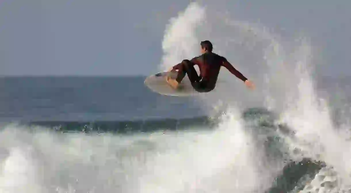 Pro surfer jumping a wave