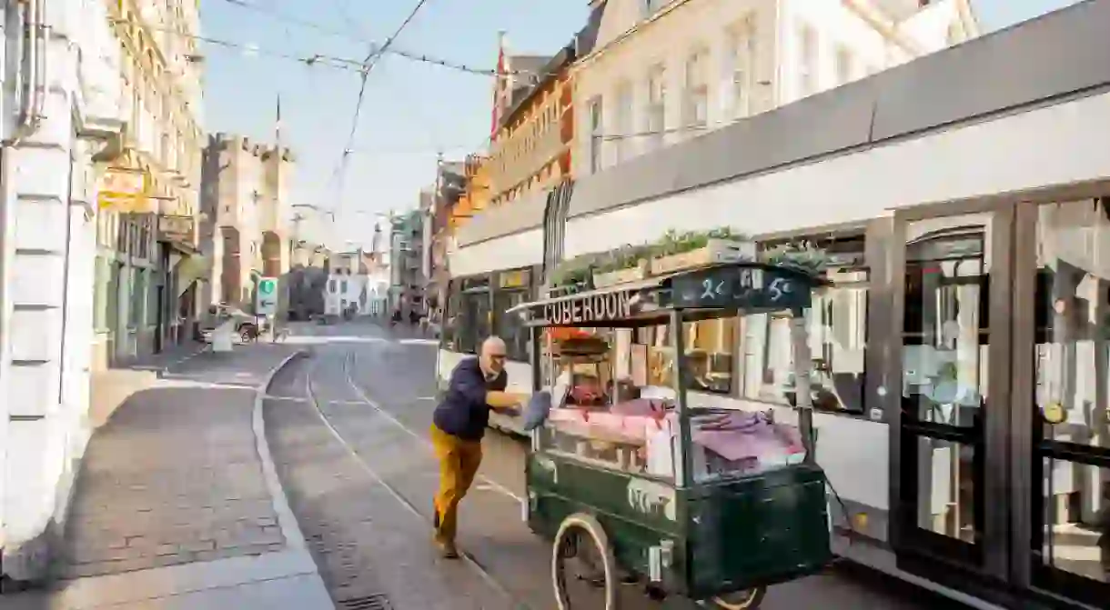 Carl Demeestere pushing his cuberdon cart down Ghent streets