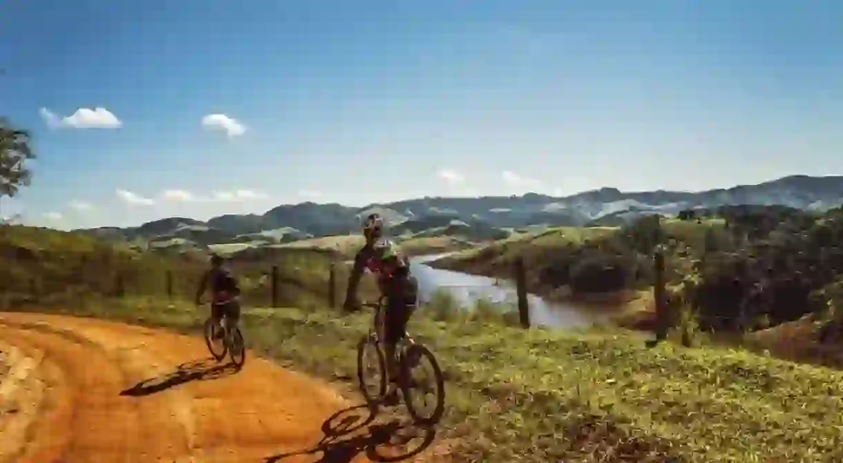 Cyclists along a river