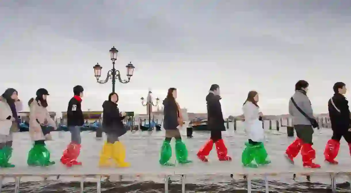 Tour group walks through high water