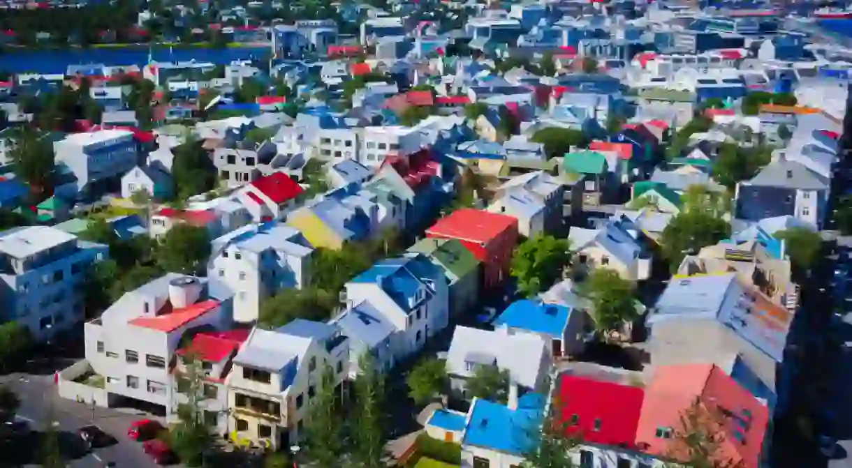 Beautiful super wide-angle aerial view of Reykjavik, Iceland with harbor and skyline mountains and scenery beyond the city, seen from the observation tower of hallgrimskirja