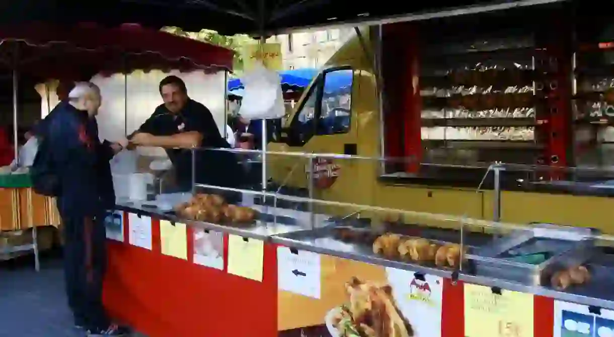 Smiling chicken merchant at a local market