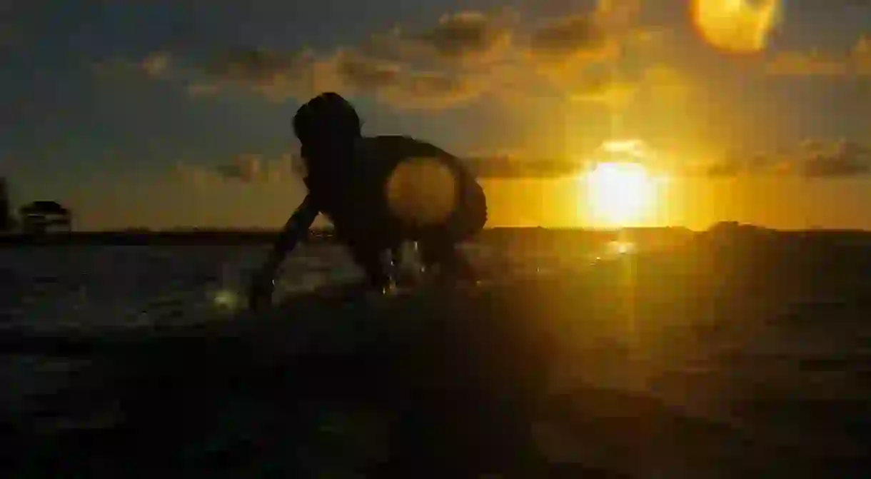 Surfing during golden hour in Siargao