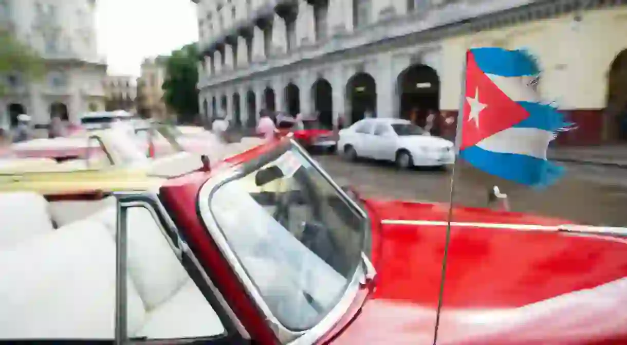 Classic car with Cuban flag