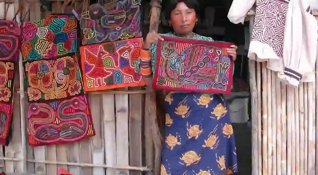 Guna Yala woman showcasing her molas (fabrics)