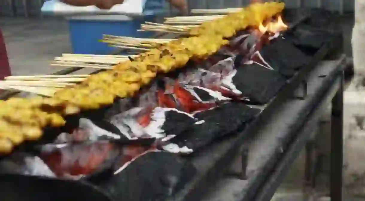 Satay being cooked over charcoal grill