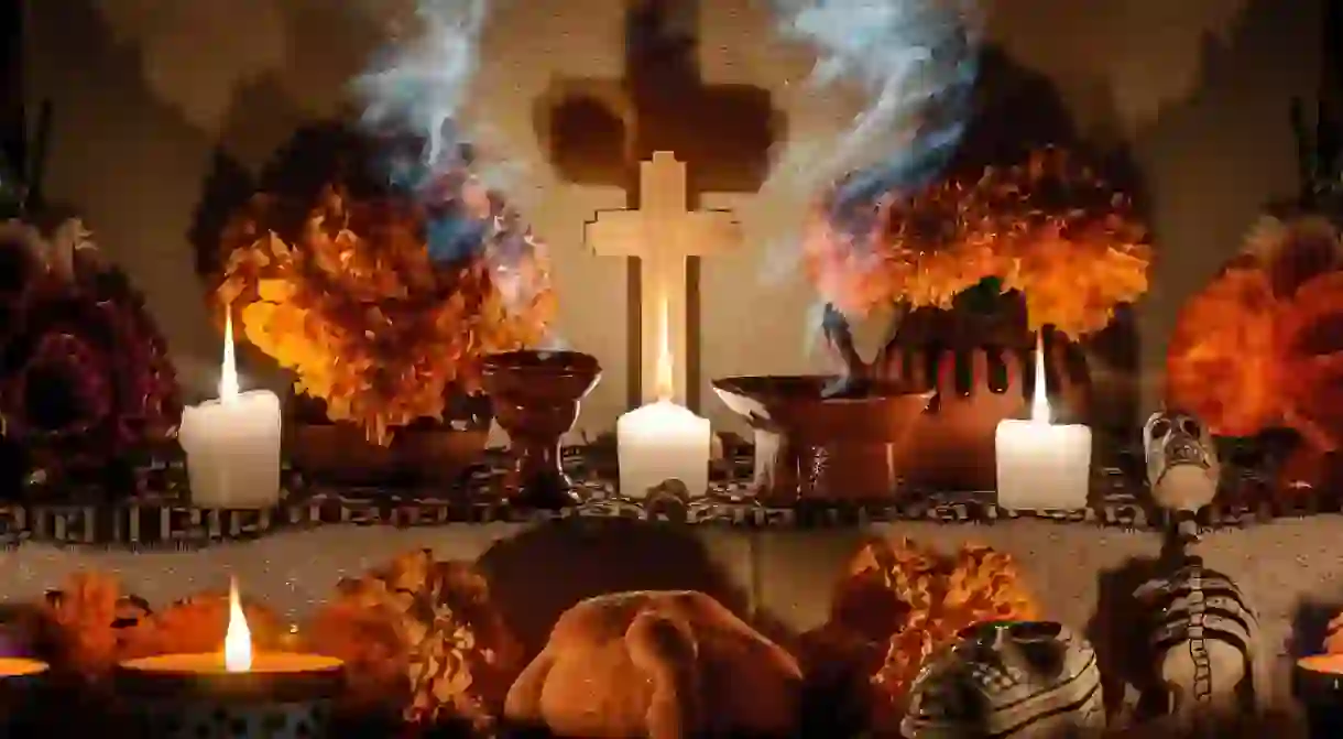 Traditional day of the dead altar with pan de muerto and candles